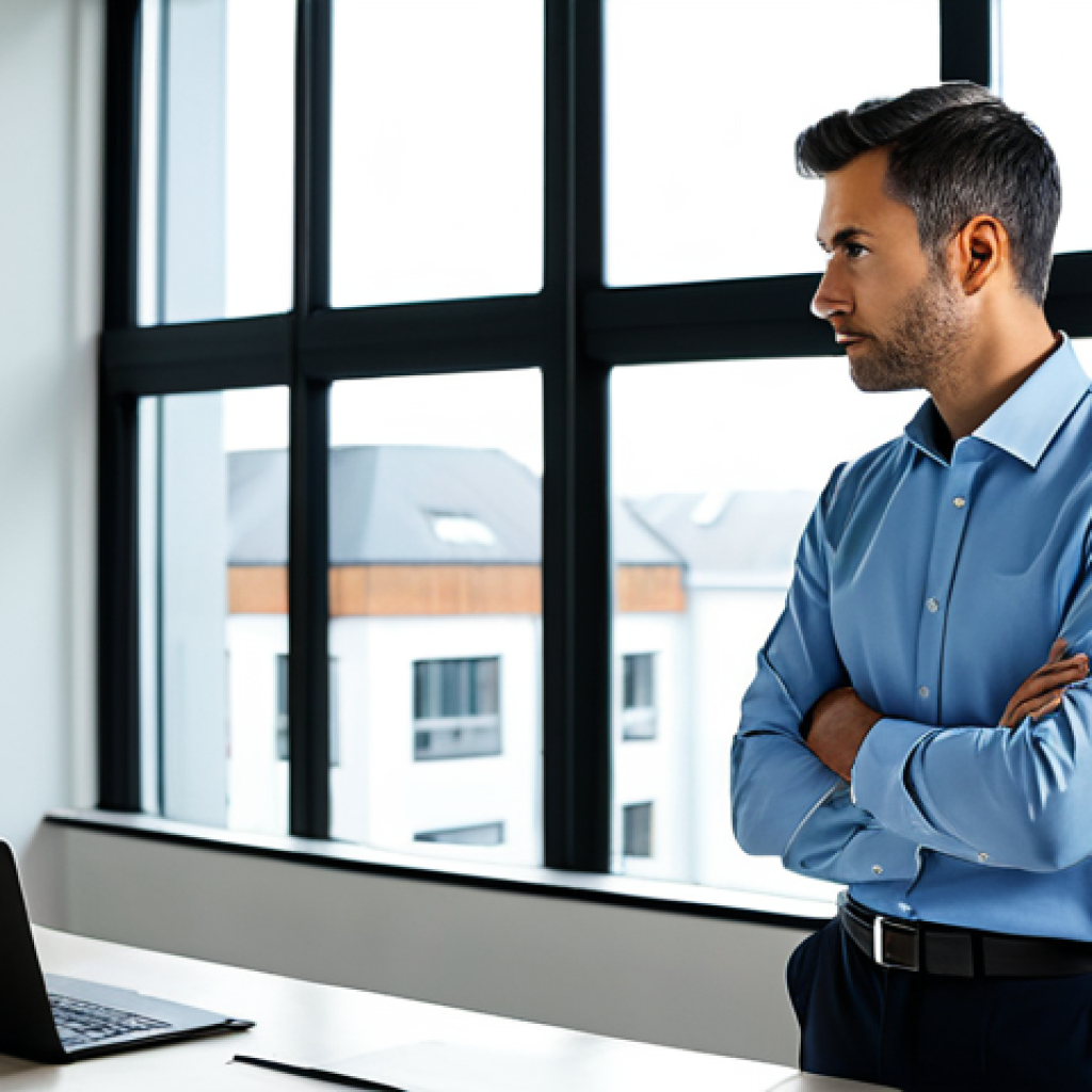 A professional man, fully clothed in a modest business shirt and smart trousers, stands thoughtfully by a large window in a contemporary, brightly lit office. His gaze is directed outwards, suggesting introspection and a connection to his professional purpose. The clean, modern workspace features ergonomic furniture and a discreet laptop on a desk in the background. The ambiance is calm and inspiring, emphasizing a redefinition of work meaning. perfect anatomy, correct proportions, natural pose, well-formed hands, proper finger count, appropriate attire, professional dress, safe for work, appropriate content, high-quality, professional photography.